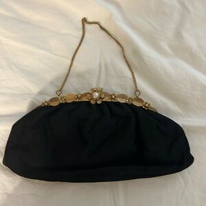 Vintage black satin clutch with gold tone accents and chain. Snap closure